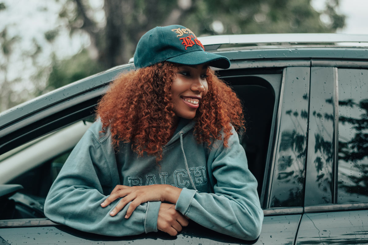 Girl leaning out of car window 